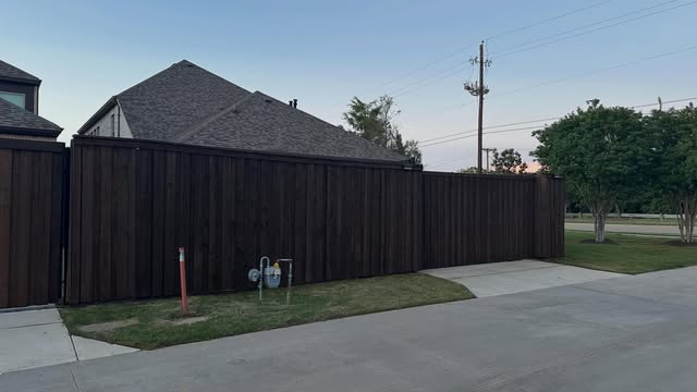 Modern dark-stained fence